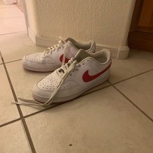 Red and white low top women’s Nikes